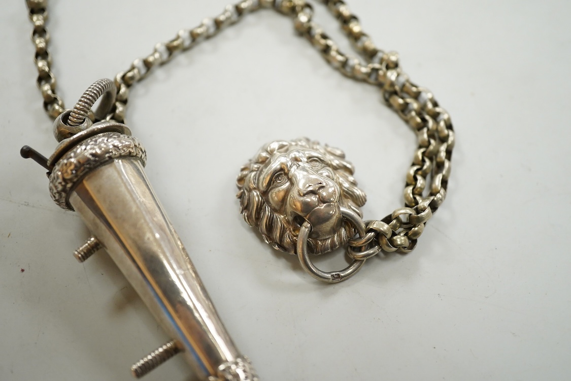 A Victorian silver whistle and case by George Unite, Birmingham, 1860, 93mm, suspended from a white metal chain with lion mask mount.